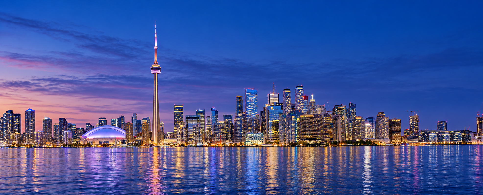 Toronto skyline across Lake Ontario at blue hour